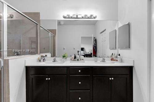 3772 Southeast 2nd Drive, Unit 3772 Homestead, FL 33033 - Photo 22 of 36 a bathroom with double sink and a mirror