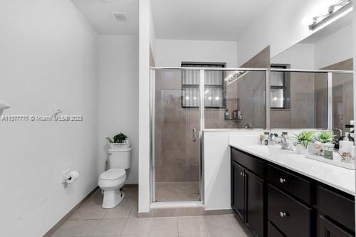3772 Southeast 2nd Drive, Unit 3772 Homestead, FL 33033 - Photo 23 of 36 a spacious bathroom with a granite countertop sink a toilet and shower