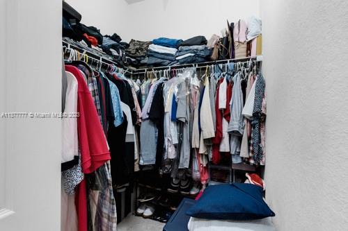 3772 Southeast 2nd Drive, Unit 3772 Homestead, FL 33033 - Photo 24 of 36 a view of walk in closet with clothes and shoes