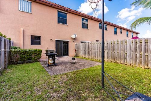 3772 Southeast 2nd Drive, Unit 3772 Homestead, FL 33033 - Photo 28 of 36 a view of a backyard with plants and patio
