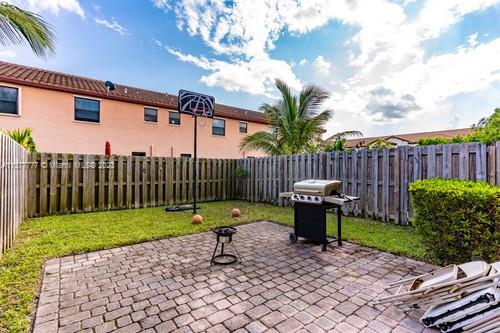 3772 Southeast 2nd Drive, Unit 3772 Homestead, FL 33033 - Photo 29 of 36 a view of a chair and tables in the backyard