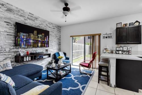3772 Southeast 2nd Drive, Unit 3772 Homestead, FL 33033 - Photo 4 of 36 a living room with furniture and a flat screen tv