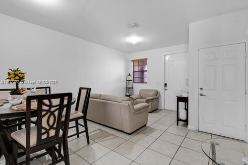 3772 Southeast 2nd Drive, Unit 3772 Homestead, FL 33033 - Photo 7 of 36 a living room with furniture and a dining table
