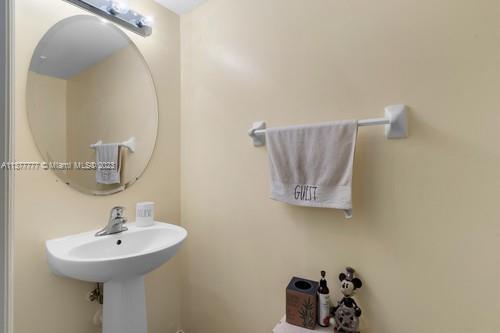 3772 Southeast 2nd Drive, Unit 3772 Homestead, FL 33033 - Photo 8 of 36 a bathroom with a sink and mirror