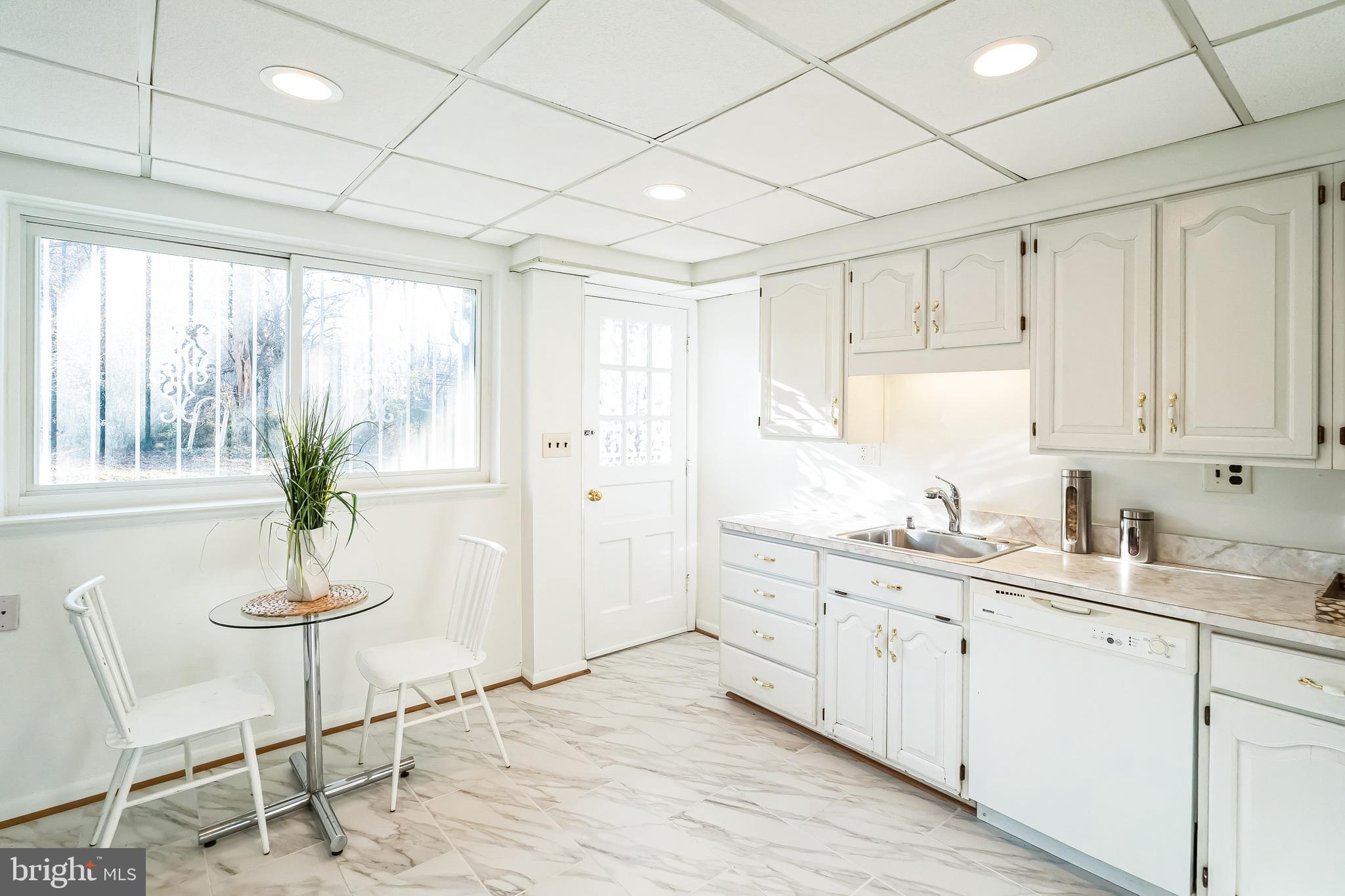 2215 Solmar Drive Silver Spring, MD 20904 - Photo 16 of 34 a kitchen with a sink potted plant and cabinets