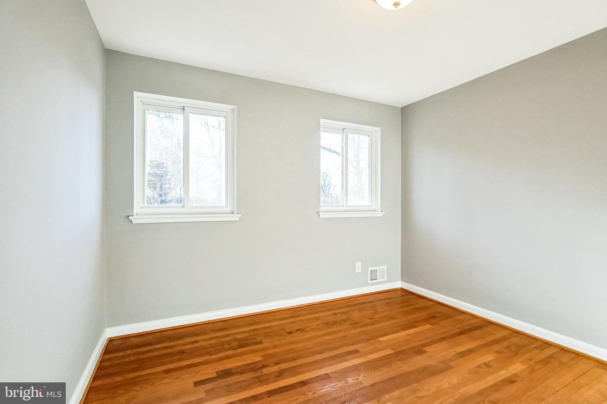 2215 Solmar Drive Silver Spring, MD 20904 - Photo 31 of 34 an empty room with wooden floor and windows