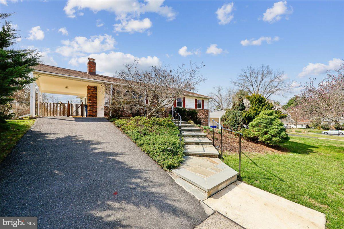 11924 Fernshire Road Gaithersburg, MD 20878 - Photo 1 of 74 a front view of a house with a yard and potted plants