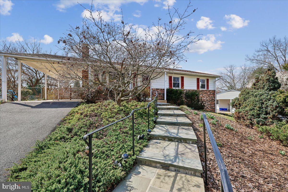 11924 Fernshire Road Gaithersburg, MD 20878 - Photo 2 of 74 a front view of a house with a yard and potted plants