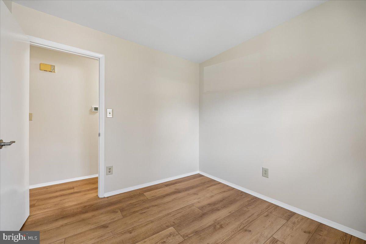 11924 Fernshire Road Gaithersburg, MD 20878 - Photo 26 of 74 a view of an empty room with wooden floor and a window