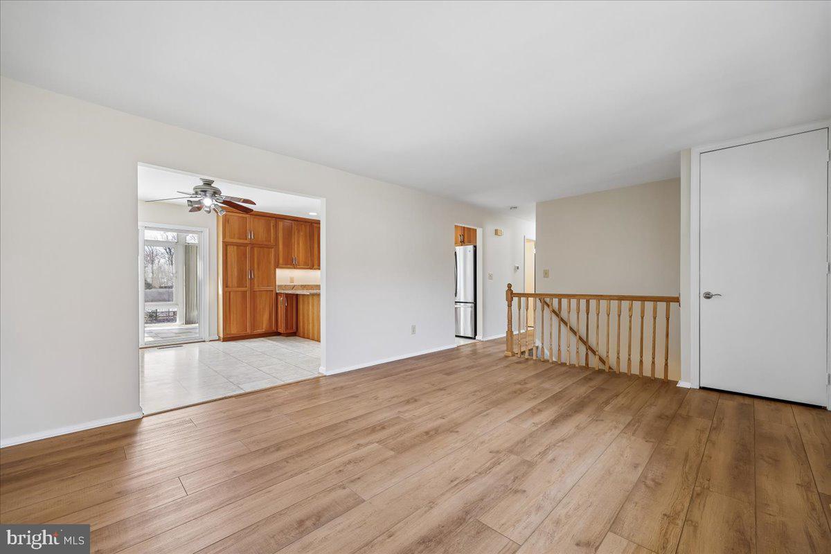 11924 Fernshire Road Gaithersburg, MD 20878 - Photo 39 of 74 a view of an empty room with wooden floor and a window