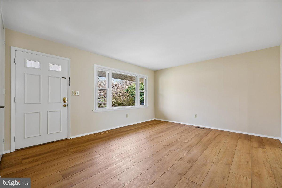 11924 Fernshire Road Gaithersburg, MD 20878 - Photo 40 of 74 a view of an empty room with wooden floor and a window