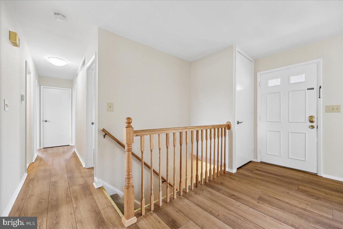 11924 Fernshire Road Gaithersburg, MD 20878 - Photo 4 of 74 a view of a hallway with wooden floor