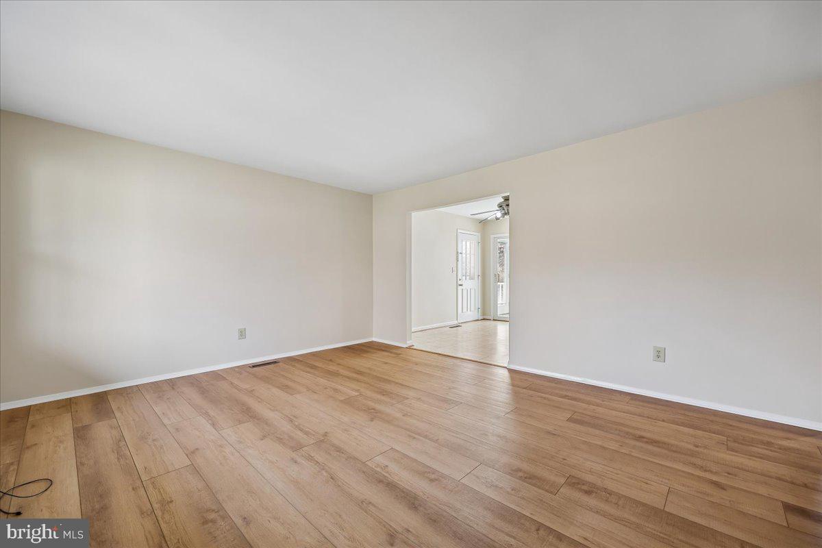 11924 Fernshire Road Gaithersburg, MD 20878 - Photo 41 of 74 a view of an empty room with wooden floor