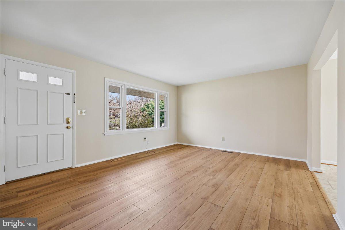 11924 Fernshire Road Gaithersburg, MD 20878 - Photo 5 of 74 a view of an empty room with wooden floor and a window