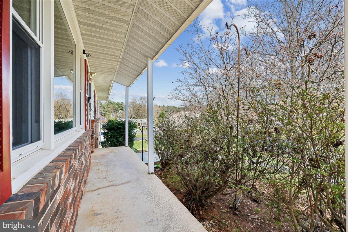 11924 Fernshire Road Gaithersburg, MD 20878 - Photo 55 of 74 a view of a patio with table and chairs and floor to ceiling window