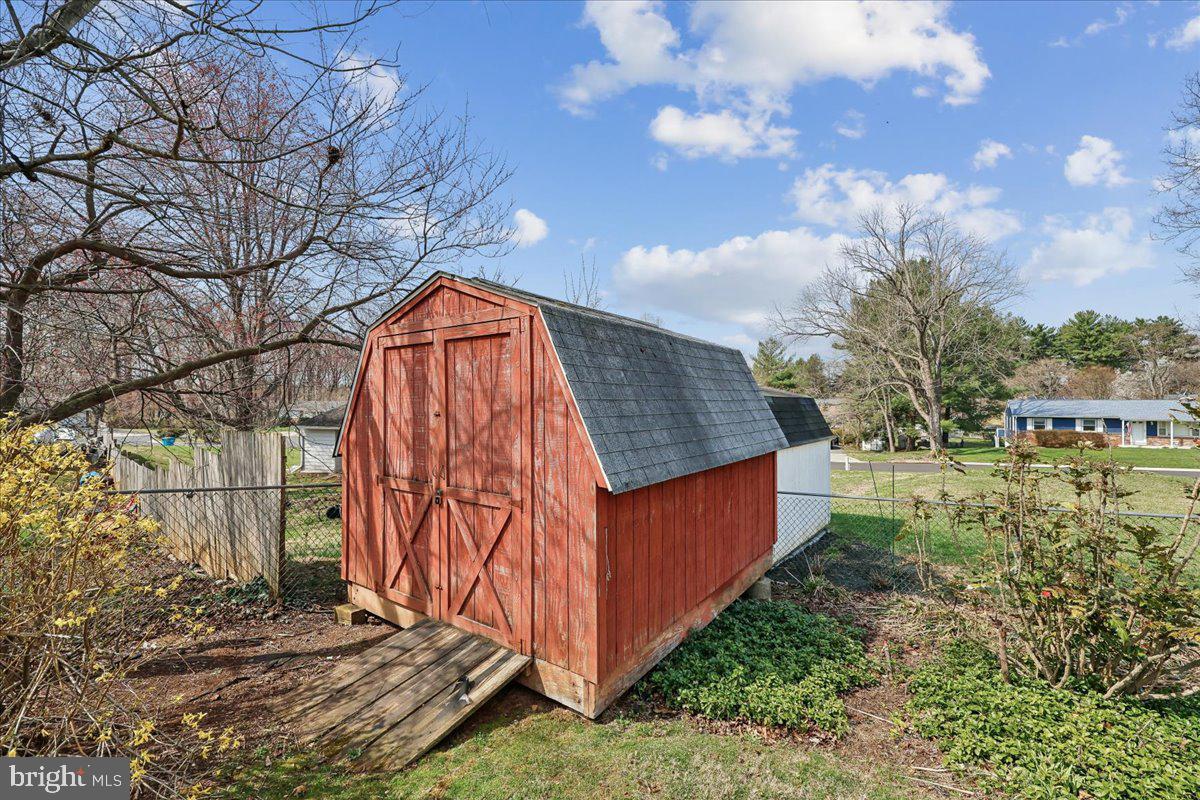 11924 Fernshire Road Gaithersburg, MD 20878 - Photo 63 of 74 Charming red shed in a serene yard.