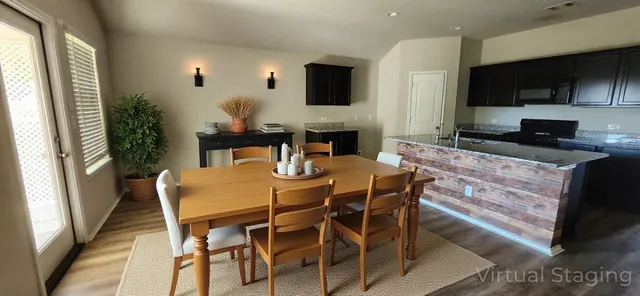 a view of a dining room with furniture and a flat screen tv