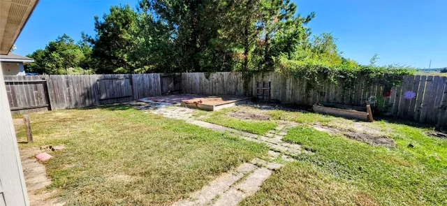 a bathroom with a small yard and wooden fence