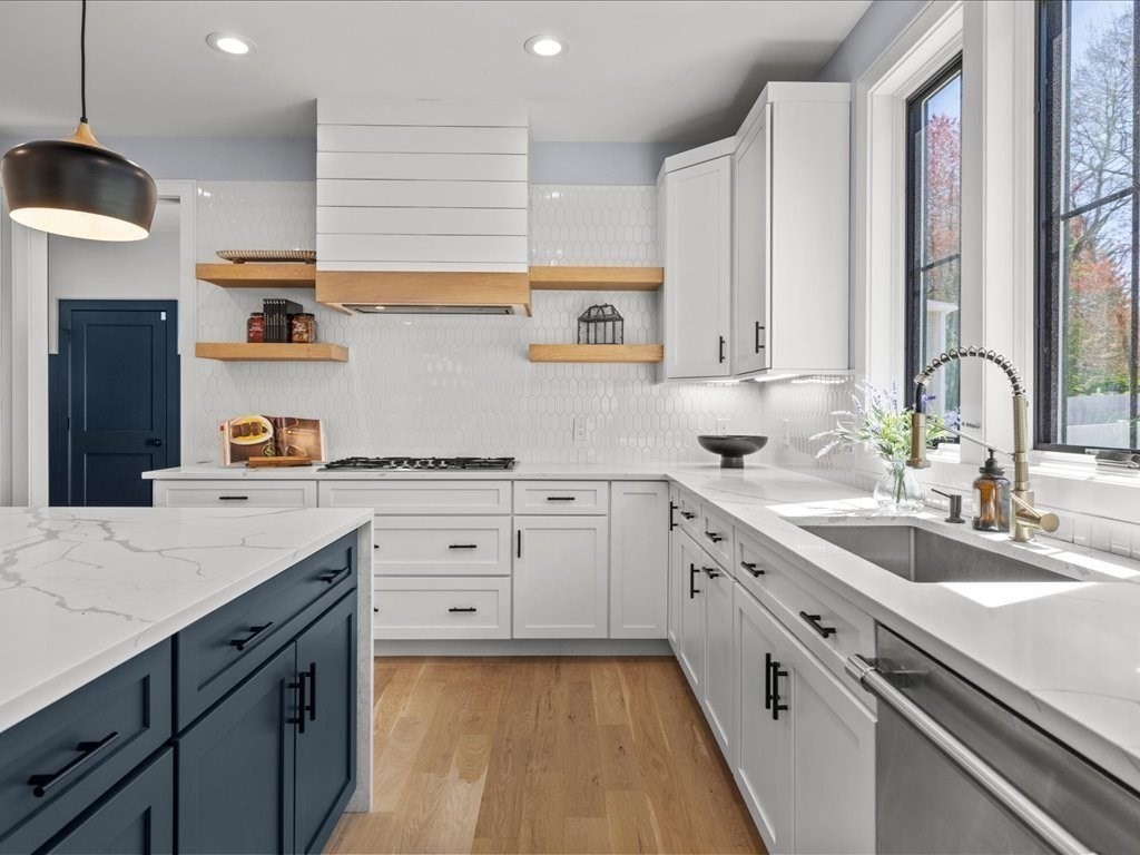 90 Norfolk Street Needham, MA 02492 - Photo 13 of 42 a kitchen with a sink dishwasher a stove and white cabinets with wooden floor
