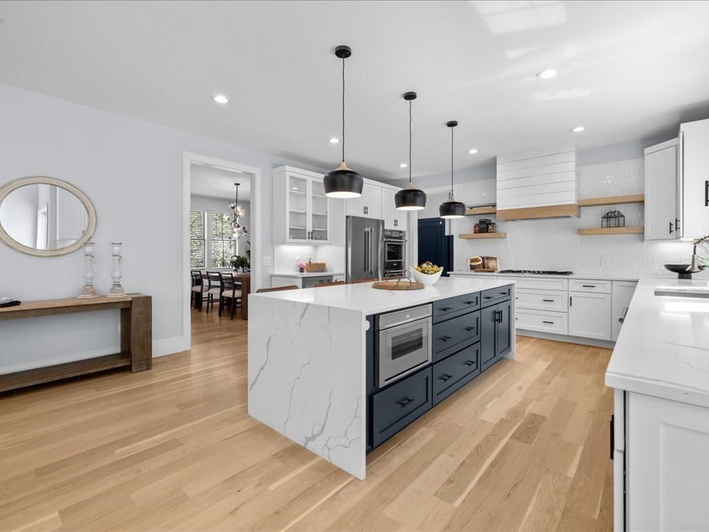 90 Norfolk Street Needham, MA 02492 - Photo 14 of 42 a kitchen with kitchen island white cabinets and white appliances