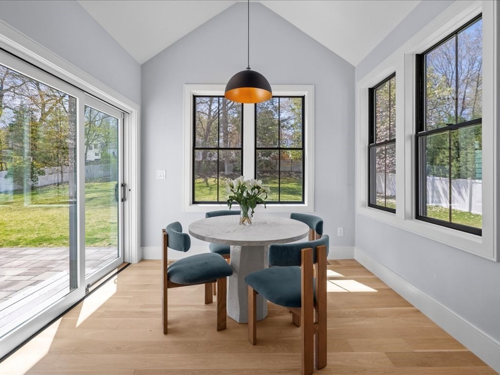 90 Norfolk Street Needham, MA 02492 - Photo 15 of 42 a dining room with furniture a chandelier and wooden floor