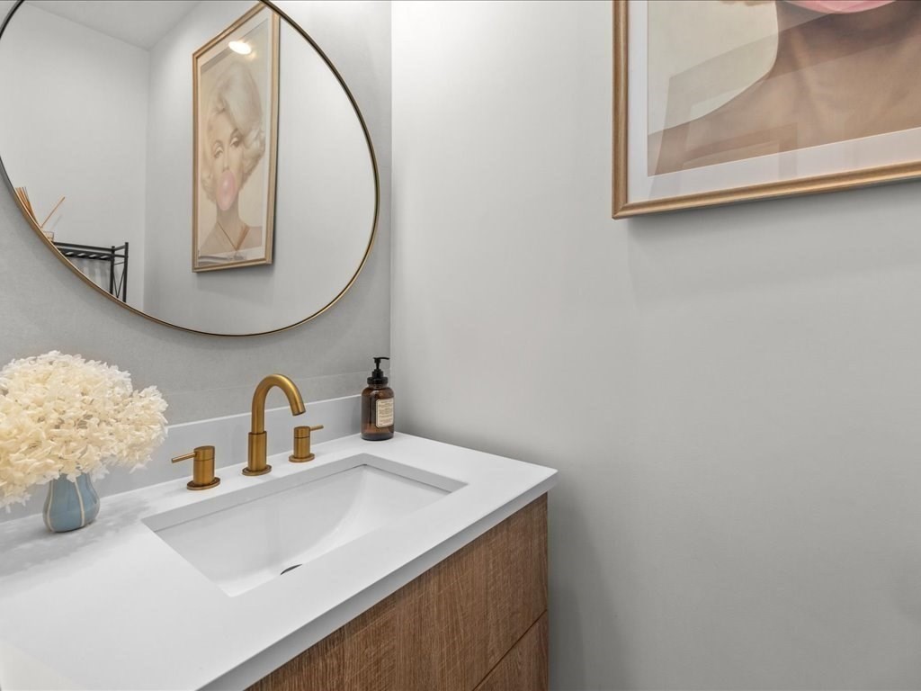 90 Norfolk Street Needham, MA 02492 - Photo 20 of 42 a bathroom with a sink and a mirror