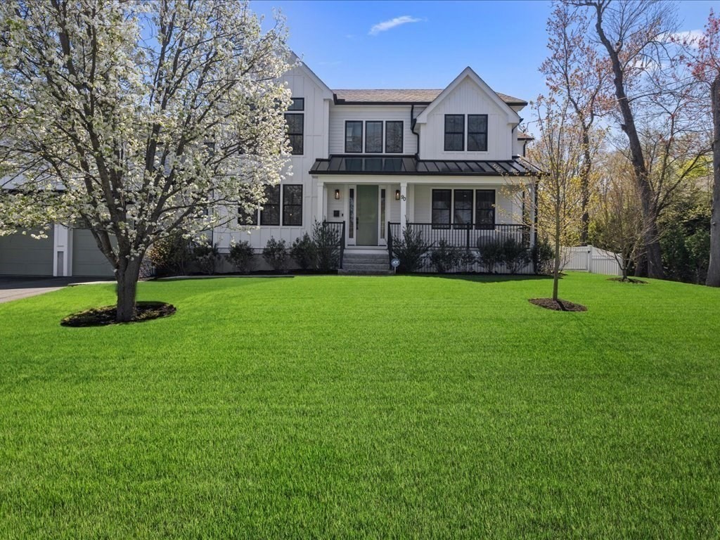 90 Norfolk Street Needham, MA 02492 - Photo 2 of 42 a front view of a house with a garden