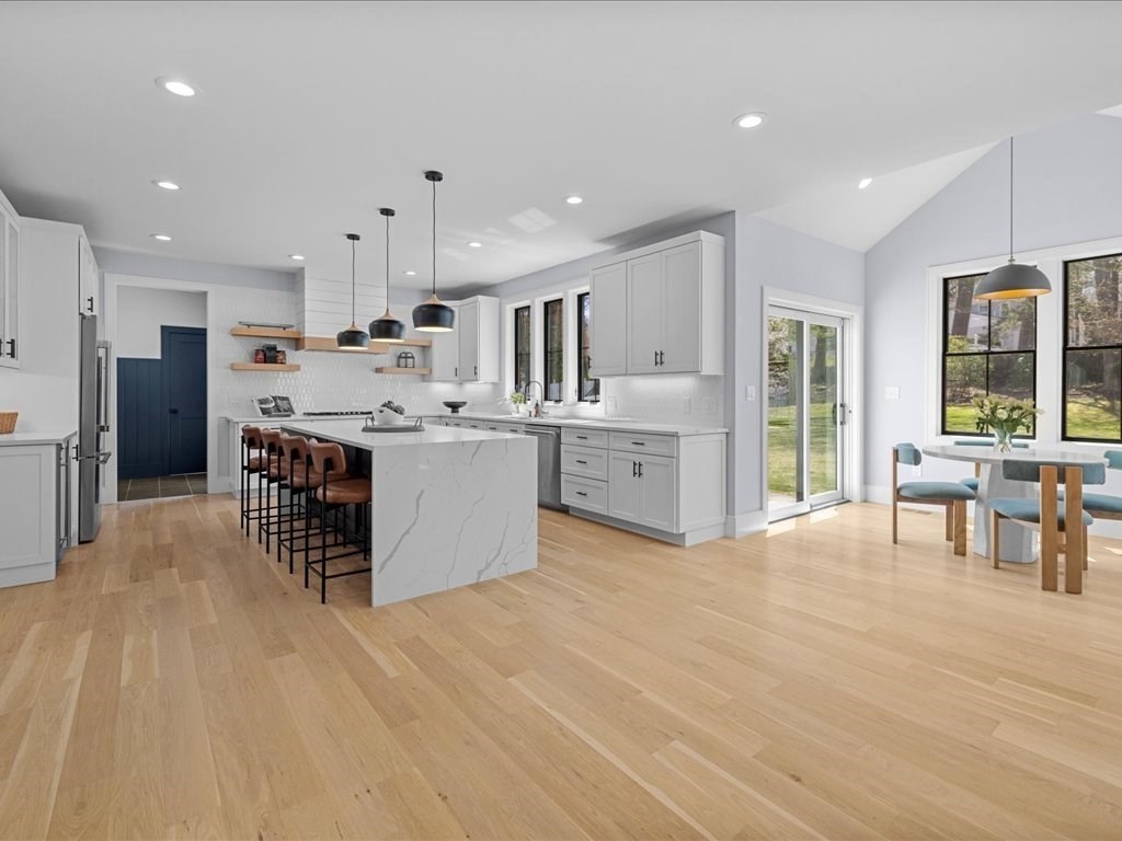 90 Norfolk Street Needham, MA 02492 - Photo 21 of 42 a large kitchen with stainless steel appliances kitchen island granite countertop a large cabinets a sink and a stove