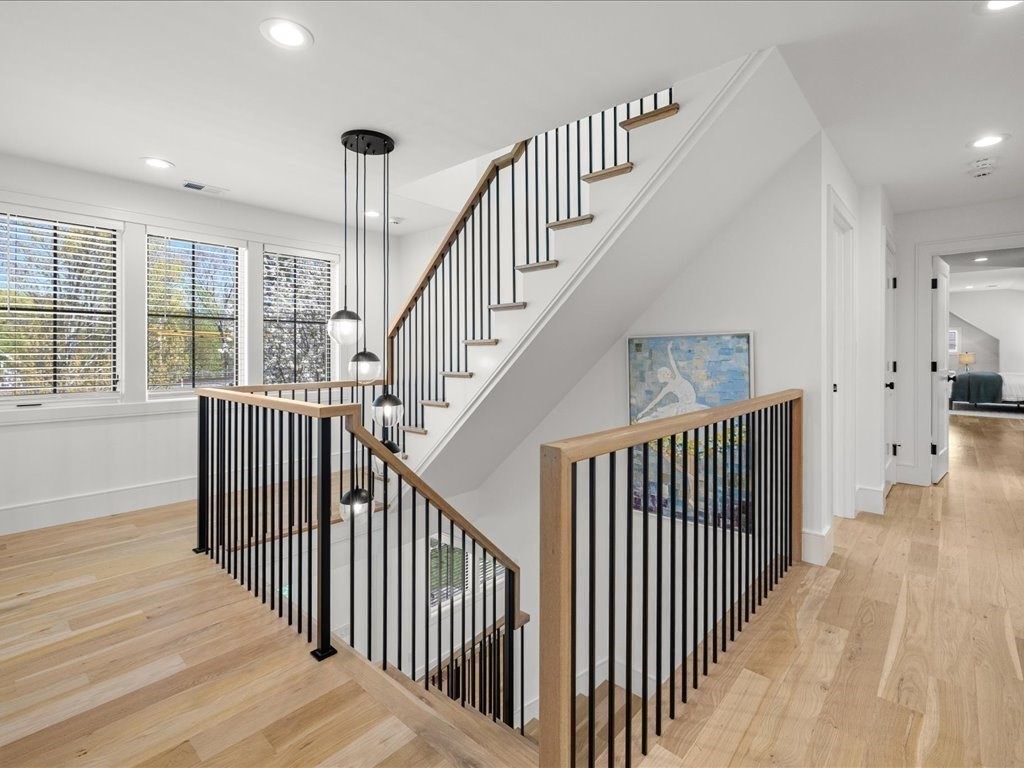 90 Norfolk Street Needham, MA 02492 - Photo 23 of 42 a view of staircase with lots of frames on wall and a large window