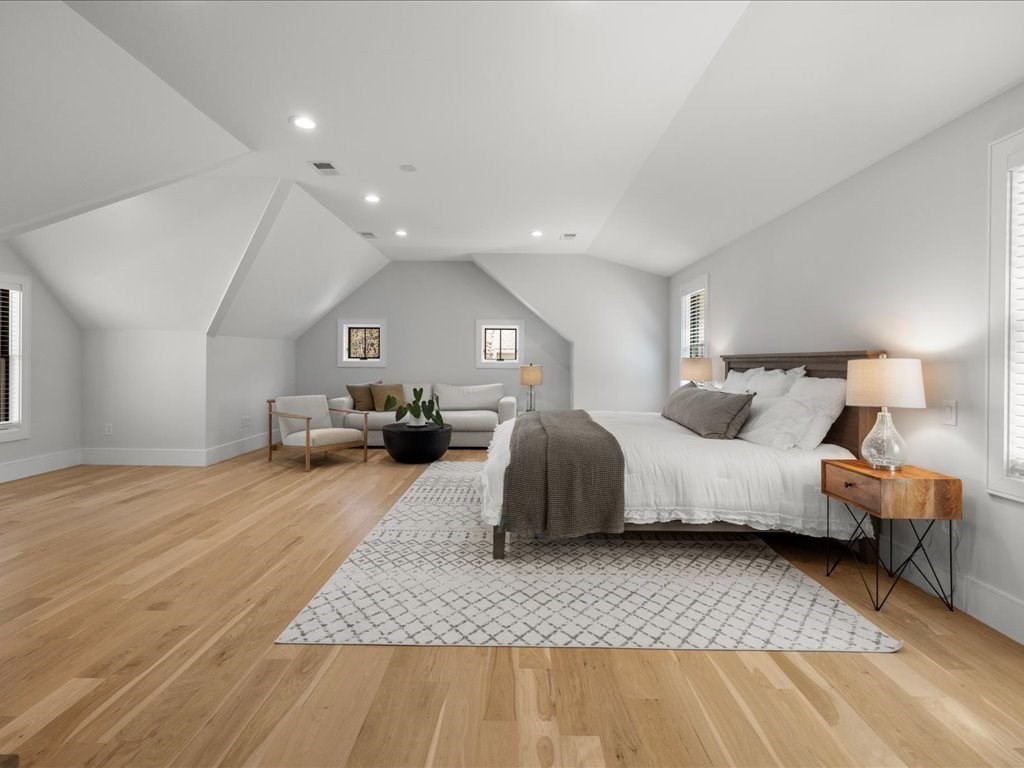 90 Norfolk Street Needham, MA 02492 - Photo 24 of 42 a spacious bedroom with a large bed and a couch