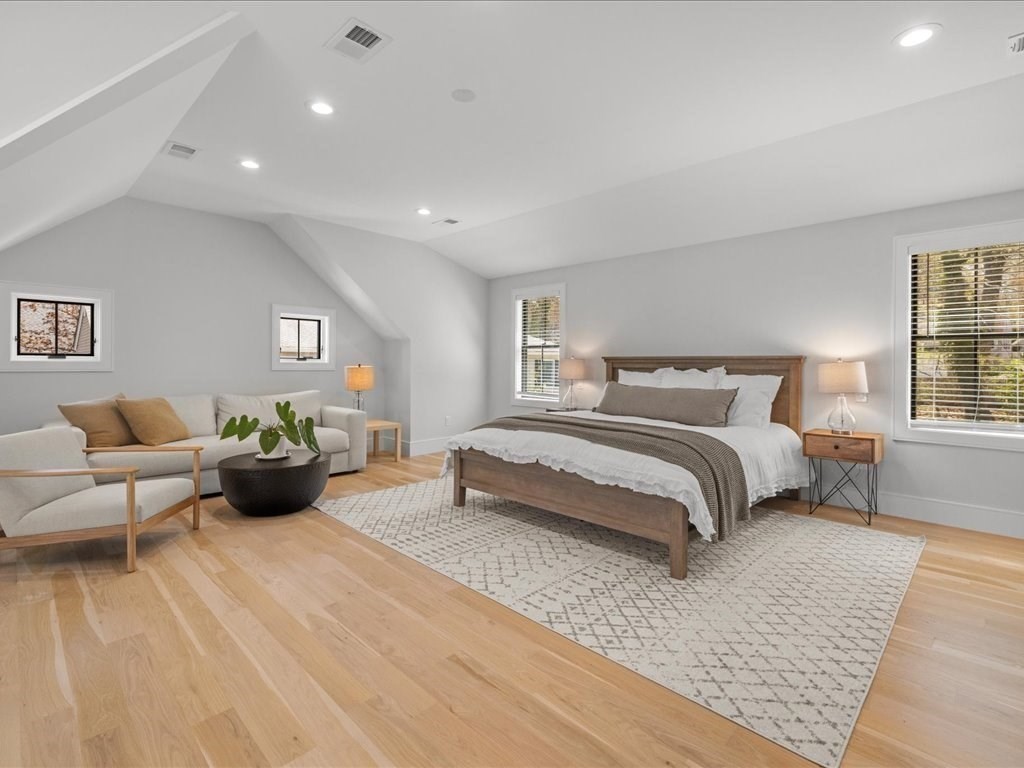 90 Norfolk Street Needham, MA 02492 - Photo 26 of 42 a bedroom with a bed and wooden floor