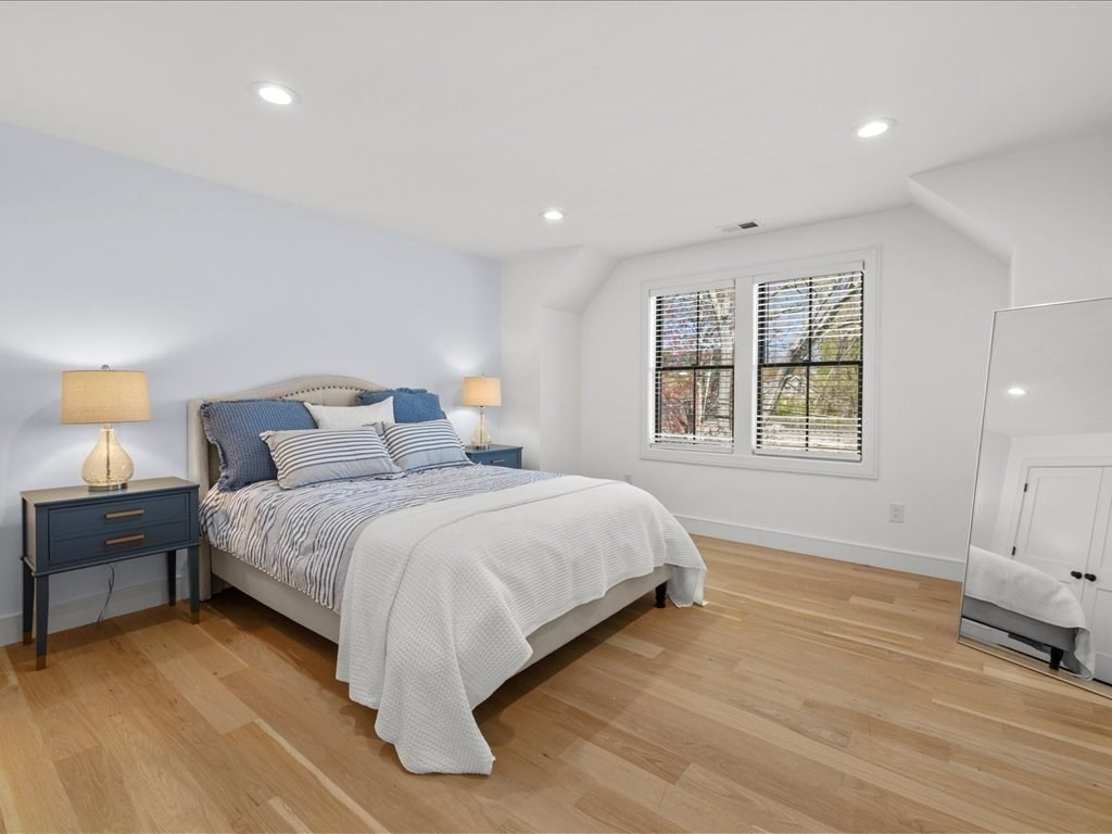 90 Norfolk Street Needham, MA 02492 - Photo 31 of 42 a spacious bedroom with a bed and wooden floor