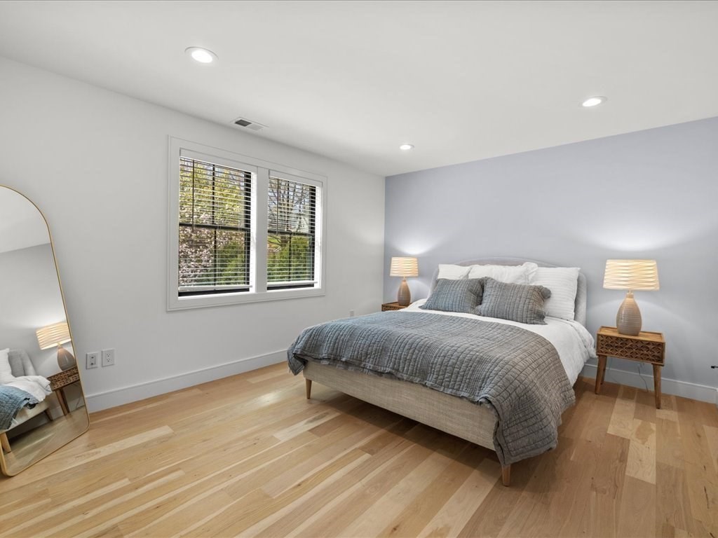 90 Norfolk Street Needham, MA 02492 - Photo 32 of 42 a bedroom with a bed and a large window