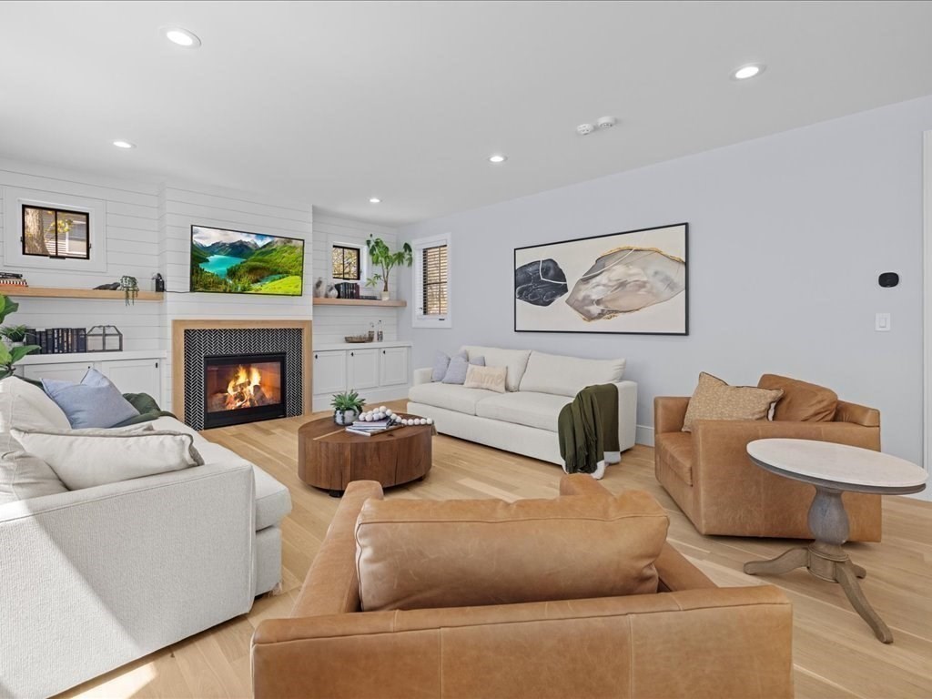 90 Norfolk Street Needham, MA 02492 - Photo 8 of 42 a living room with furniture and a fireplace