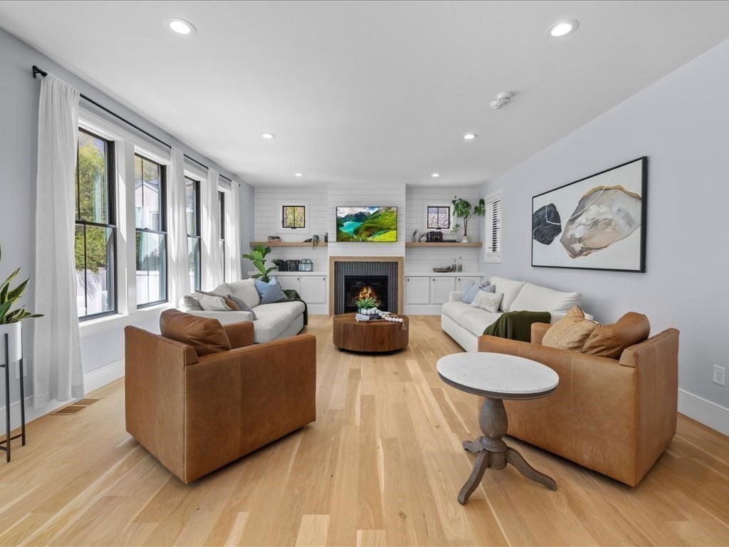 90 Norfolk Street Needham, MA 02492 - Photo 10 of 42 a living room with furniture a fireplace and a table