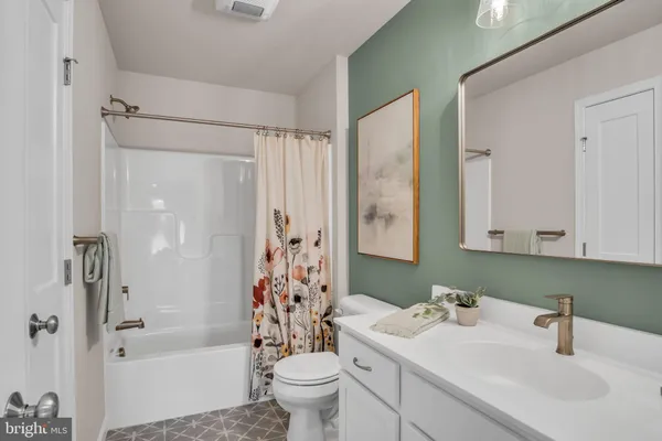 a bathroom with a sink toilet tub and shower