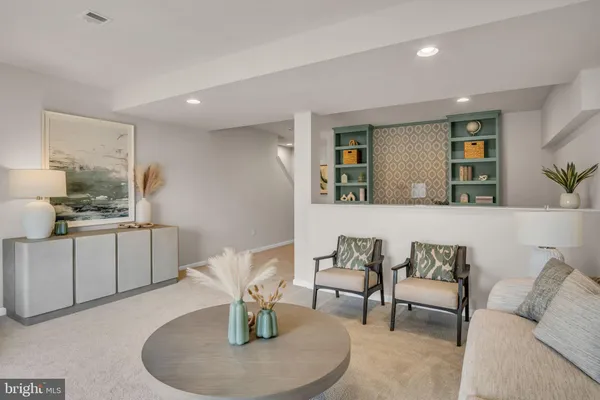 a living room with furniture and kitchen view