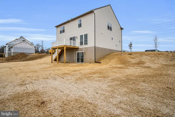 a large white house with a large parking space