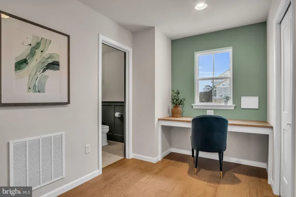 a workspace with a window and a chair