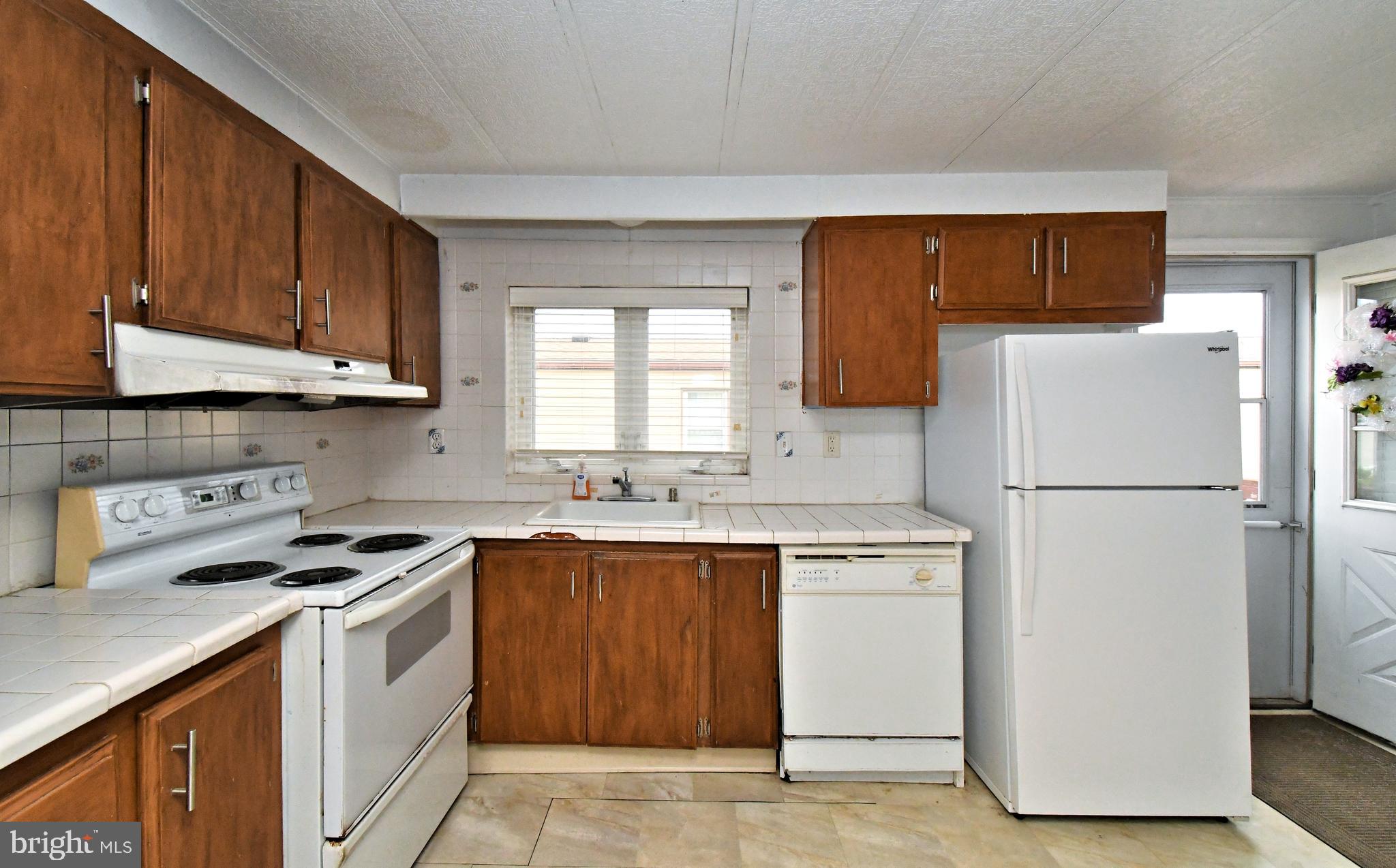 177 Bent Pine Hill North Wales, PA 19454 - Photo 2 of 14 a kitchen with a white stove top oven and refrigerator