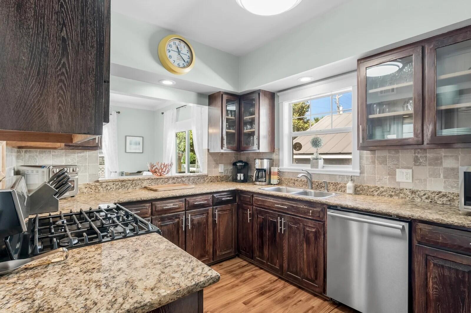 4503 John Avenue Destin, FL 32541 - Photo 14 of 51 a kitchen with stainless steel appliances granite countertop a sink stove and cabinets