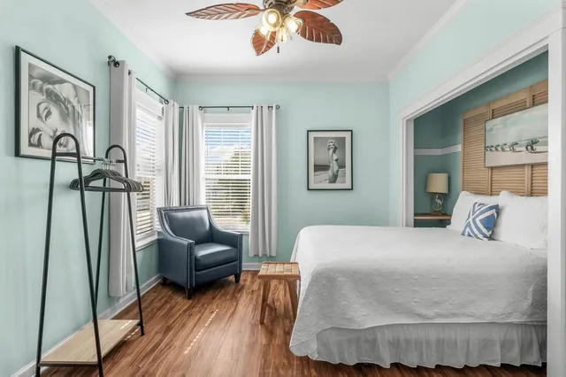 a bedroom with a bed couch and a window