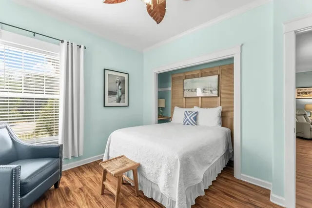 a bedroom with a bed and wooden floor