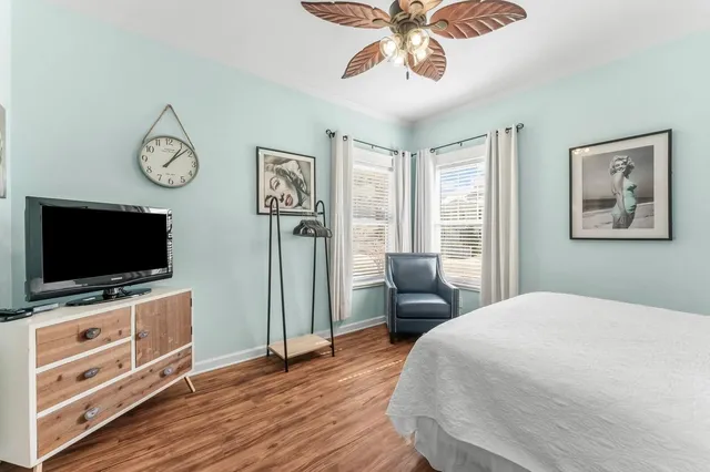 a bedroom with furniture and a flat screen tv