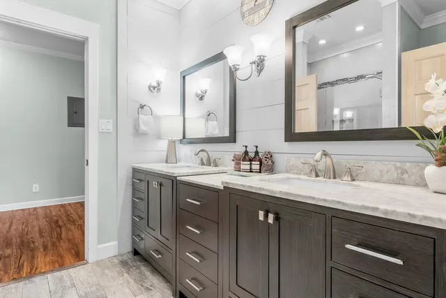 a bathroom with a granite countertop sink double vanity and a mirror