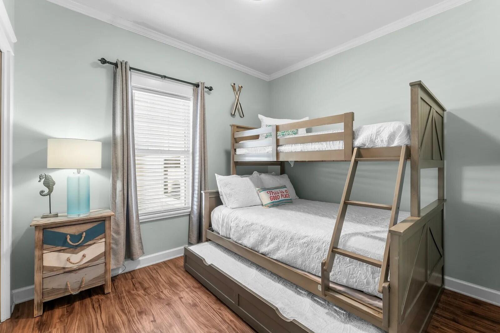 4503 John Avenue Destin, FL 32541 - Photo 21 of 51 a bedroom with a bed and wooden floor