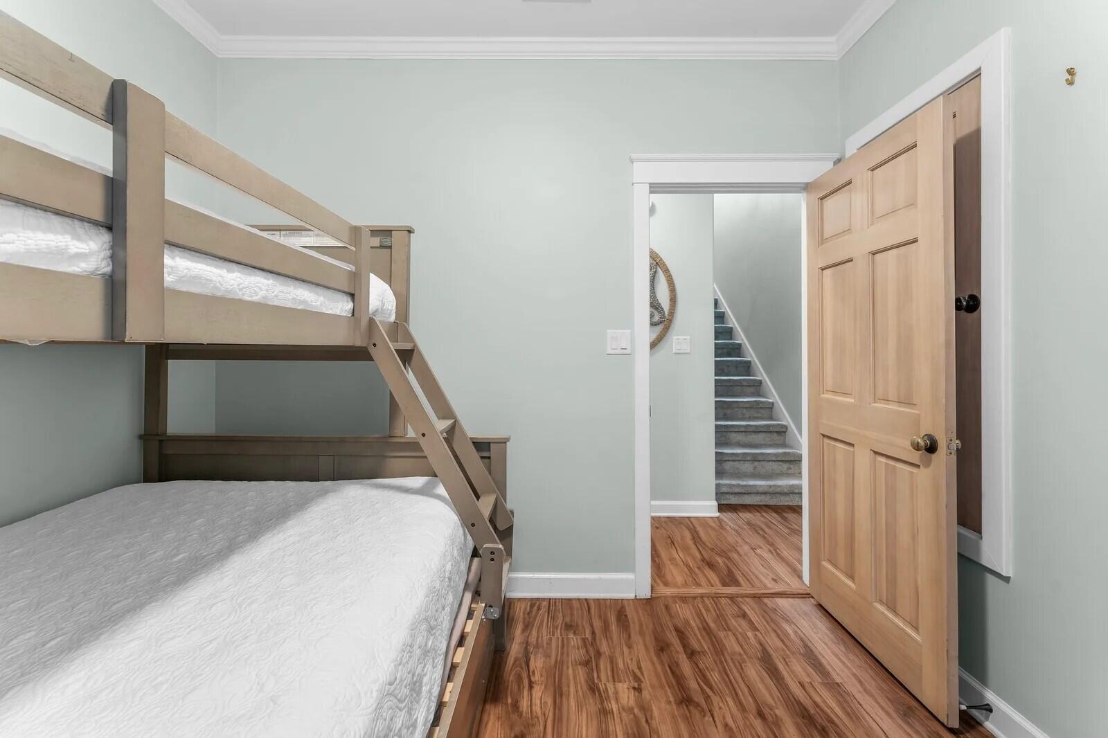 4503 John Avenue Destin, FL 32541 - Photo 22 of 51 a bedroom with a bed and a wooden floor