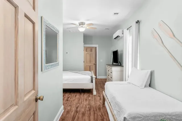 a bedroom with a bed and a flat tv screen