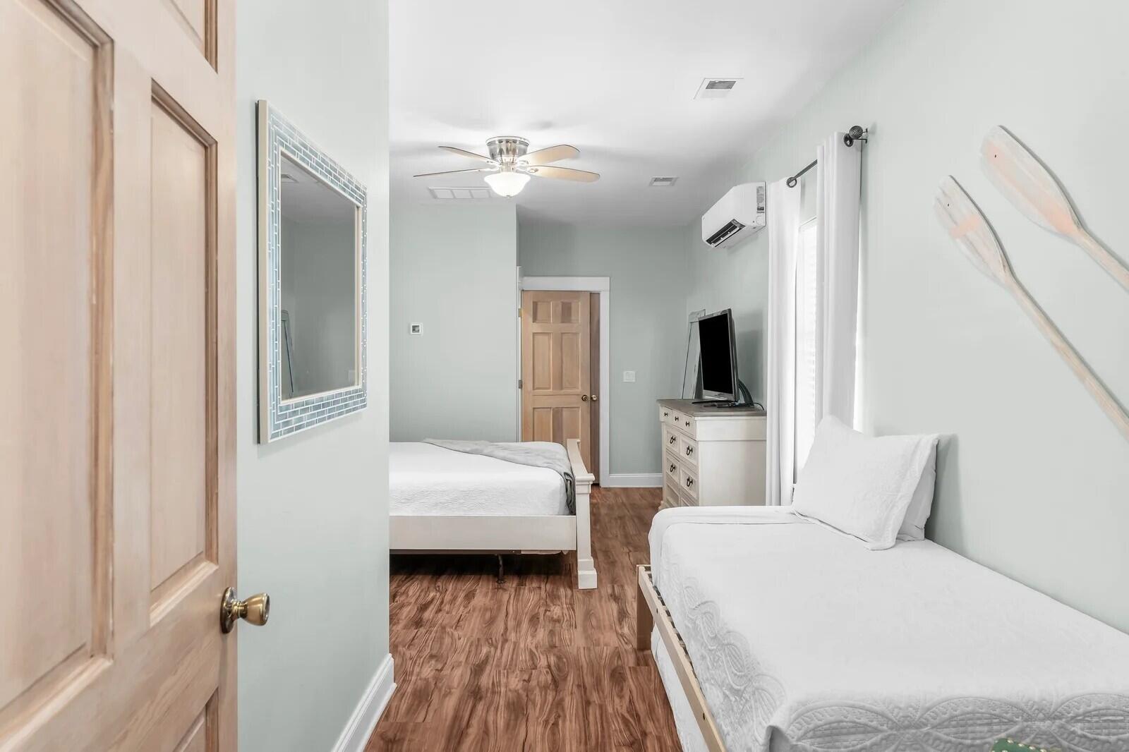 4503 John Avenue Destin, FL 32541 - Photo 23 of 51 a bedroom with a bed and a flat tv screen