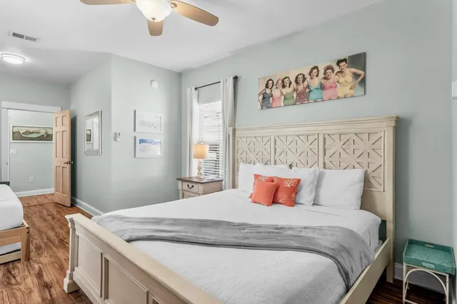 a bedroom with a large bed and a chandelier